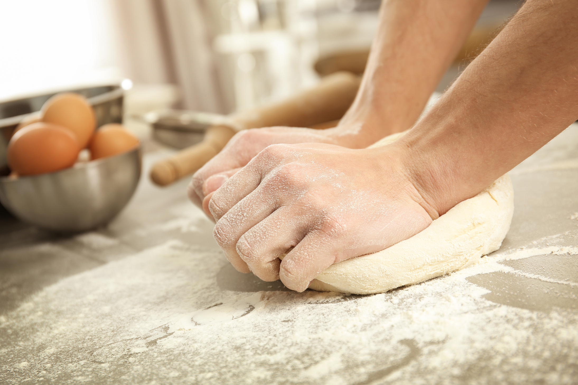 Kneading Dough on Sprinkled with Flour Table